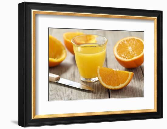 Sliced Oranges and Glass with Fresh Orange Juice-Jana Ihle-Framed Photographic Print