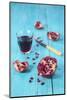 Sliced Pomegranate and a Glass of Pomegranate Juice on Turquoise Wooden Table-Jana Ihle-Mounted Photographic Print