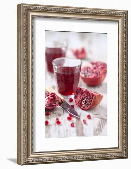 Sliced Pomegranates, Cores and Glass with Pomegranate Juice-Jana Ihle-Framed Photographic Print