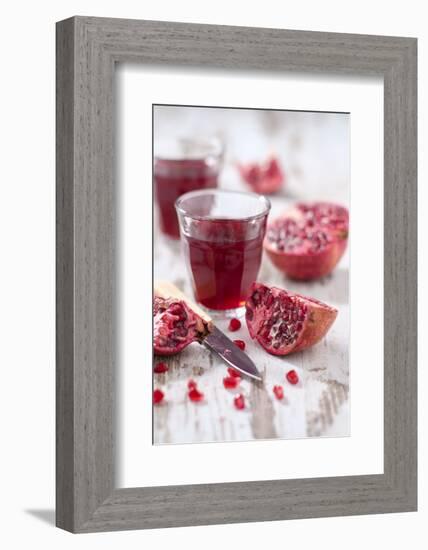 Sliced Pomegranates, Cores and Glass with Pomegranate Juice-Jana Ihle-Framed Photographic Print