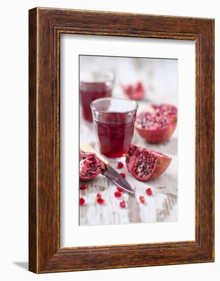 Sliced Pomegranates, Cores and Glass with Pomegranate Juice-Jana Ihle-Framed Photographic Print