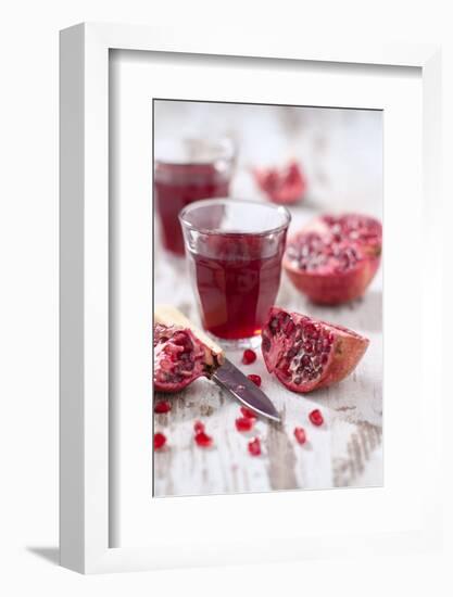 Sliced Pomegranates, Cores and Glass with Pomegranate Juice-Jana Ihle-Framed Photographic Print