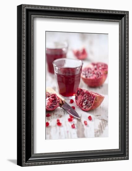 Sliced Pomegranates, Cores and Glass with Pomegranate Juice-Jana Ihle-Framed Photographic Print