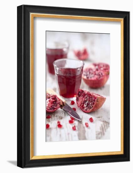 Sliced Pomegranates, Cores and Glass with Pomegranate Juice-Jana Ihle-Framed Photographic Print
