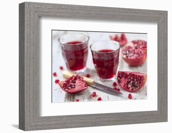 Sliced Pomegranates, Cores and Glasses with Pomegranate Juice-Jana Ihle-Framed Photographic Print