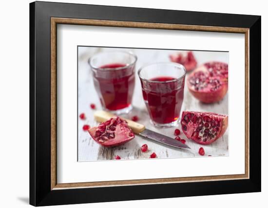 Sliced Pomegranates, Cores and Glasses with Pomegranate Juice-Jana Ihle-Framed Photographic Print