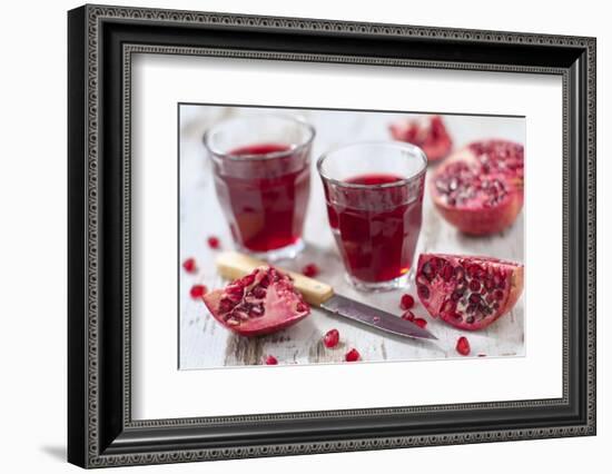 Sliced Pomegranates, Cores and Glasses with Pomegranate Juice-Jana Ihle-Framed Photographic Print