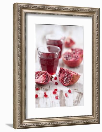 Sliced Pomegranates, Seeds and Glass with Pomegranate Juice-Jana Ihle-Framed Photographic Print