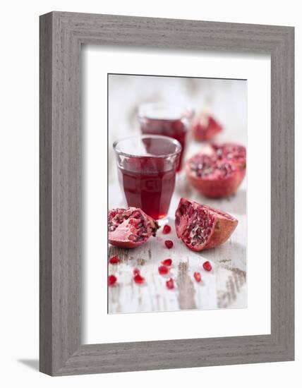 Sliced Pomegranates, Seeds and Glass with Pomegranate Juice-Jana Ihle-Framed Photographic Print