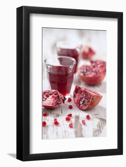 Sliced Pomegranates, Seeds and Glass with Pomegranate Juice-Jana Ihle-Framed Photographic Print