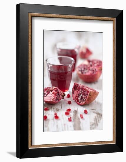 Sliced Pomegranates, Seeds and Glass with Pomegranate Juice-Jana Ihle-Framed Photographic Print