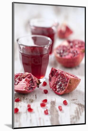 Sliced Pomegranates, Seeds and Glass with Pomegranate Juice-Jana Ihle-Mounted Photographic Print