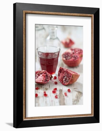Sliced Pomegranates, Seeds and Glass with Pomegranate Juice-Jana Ihle-Framed Photographic Print