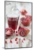 Sliced Pomegranates, Seeds and Glass with Pomegranate Juice-Jana Ihle-Mounted Photographic Print