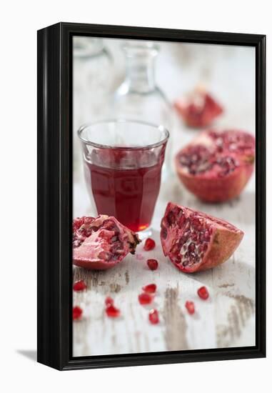 Sliced Pomegranates, Seeds and Glass with Pomegranate Juice-Jana Ihle-Framed Premier Image Canvas