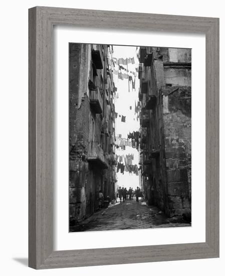 Slum Street with Laundry Hanging Between Buildings-Alfred Eisenstaedt-Framed Photographic Print