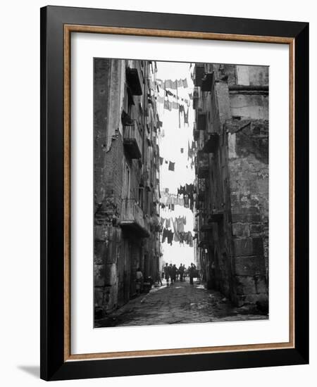 Slum Street with Laundry Hanging Between Buildings-Alfred Eisenstaedt-Framed Photographic Print