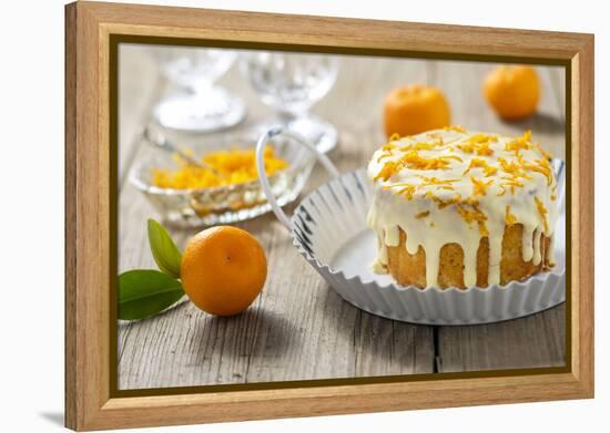 Small Orange Cake with White Icing on Wooden Table-Jana Ihle-Framed Premier Image Canvas