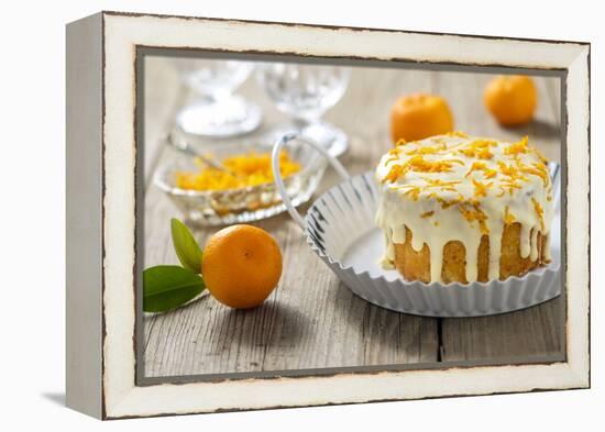 Small Orange Cake with White Icing on Wooden Table-Jana Ihle-Framed Premier Image Canvas