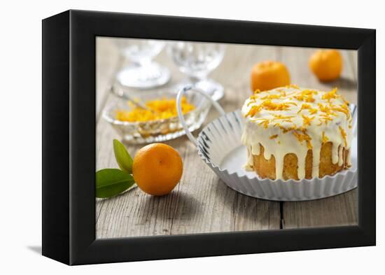 Small Orange Cake with White Icing on Wooden Table-Jana Ihle-Framed Premier Image Canvas