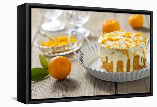 Small Orange Cake with White Icing on Wooden Table-Jana Ihle-Framed Premier Image Canvas