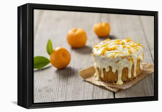 Small Orange Cake with White Icing on Wooden Table-Jana Ihle-Framed Premier Image Canvas