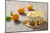 Small Orange Cake with White Icing on Wooden Table-Jana Ihle-Mounted Photographic Print