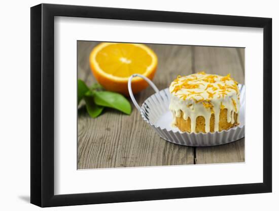 Small Orange Cake with White Icing on Wooden Table-Jana Ihle-Framed Photographic Print