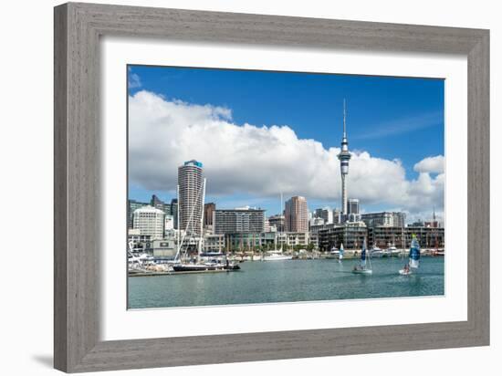 Small sailboats cruise in Auckland harbour in front of the city skyline, Auckland, New Zealand-Logan Brown-Framed Photographic Print