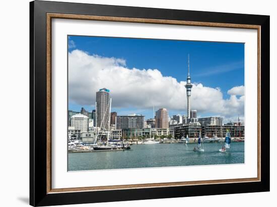 Small sailboats cruise in Auckland harbour in front of the city skyline, Auckland, New Zealand-Logan Brown-Framed Photographic Print