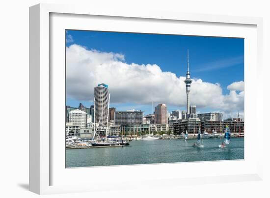 Small sailboats cruise in Auckland harbour in front of the city skyline, Auckland, New Zealand-Logan Brown-Framed Photographic Print