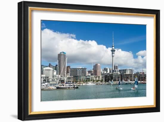 Small sailboats cruise in Auckland harbour in front of the city skyline, Auckland, New Zealand-Logan Brown-Framed Photographic Print