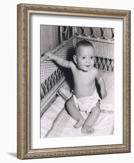 Smiling Baby Boy Sitting in Crib-null-Framed Photo