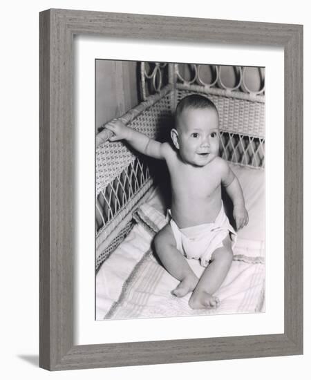 Smiling Baby Boy Sitting in Crib-null-Framed Photo