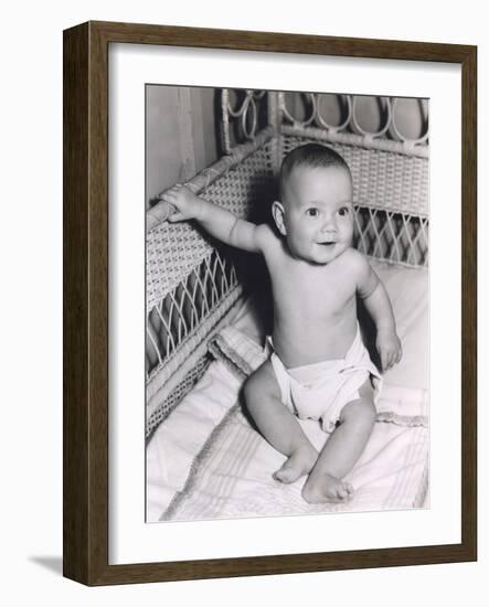 Smiling Baby Boy Sitting in Crib-null-Framed Photo