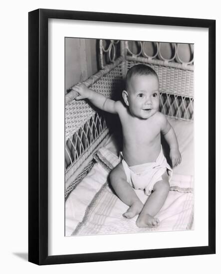 Smiling Baby Boy Sitting in Crib-null-Framed Photo