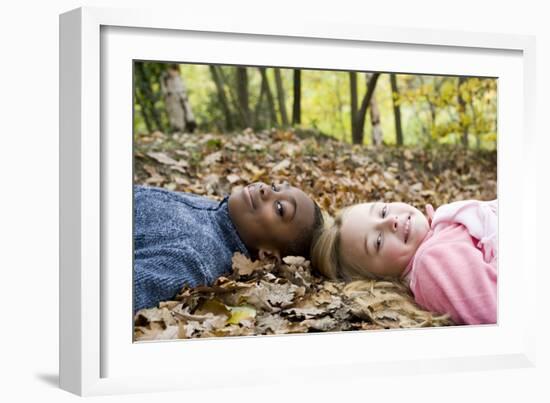 Smiling Children Lying on Autumn Leaves-Ian Boddy-Framed Photographic Print