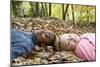 Smiling Children Lying on Autumn Leaves-Ian Boddy-Mounted Photographic Print