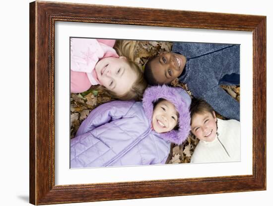 Smiling Children Lying on Autumn Leaves-Ian Boddy-Framed Photographic Print