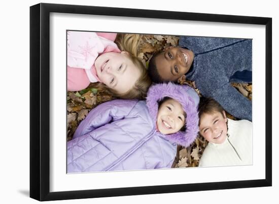 Smiling Children Lying on Autumn Leaves-Ian Boddy-Framed Photographic Print