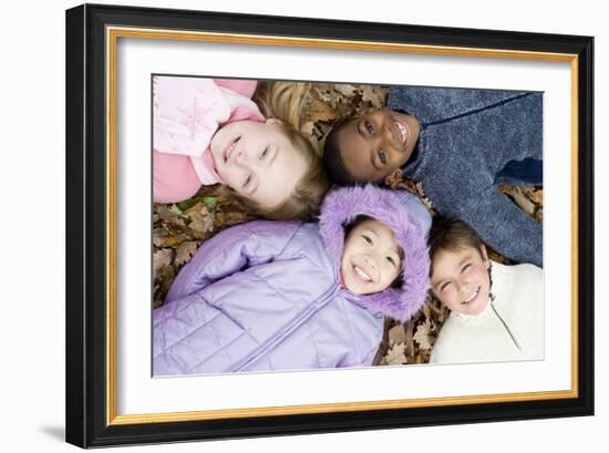 Smiling Children Lying on Autumn Leaves-Ian Boddy-Framed Photographic Print