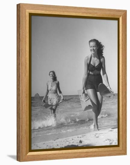 Smiling Girls Carrying Skis Out of the Water onto Beach-null-Framed Premier Image Canvas