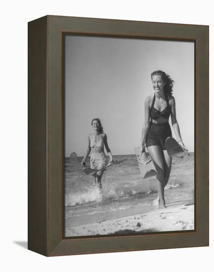 Smiling Girls Carrying Skis Out of the Water onto Beach-null-Framed Premier Image Canvas