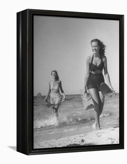 Smiling Girls Carrying Skis Out of the Water onto Beach-null-Framed Premier Image Canvas