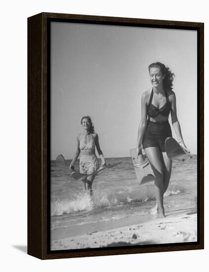 Smiling Girls Carrying Skis Out of the Water onto Beach-null-Framed Premier Image Canvas