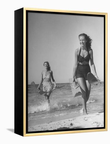 Smiling Girls Carrying Skis Out of the Water onto Beach-null-Framed Premier Image Canvas