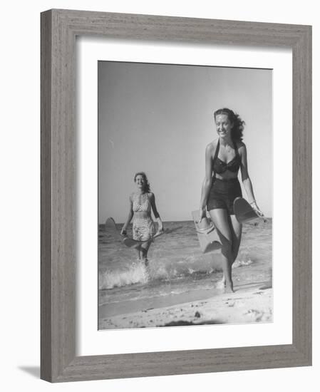 Smiling Girls Carrying Skis Out of the Water onto Beach-null-Framed Photographic Print