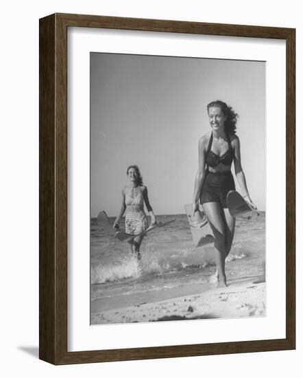 Smiling Girls Carrying Skis Out of the Water onto Beach-null-Framed Photographic Print