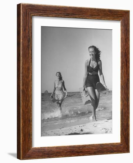 Smiling Girls Carrying Skis Out of the Water onto Beach-null-Framed Photographic Print