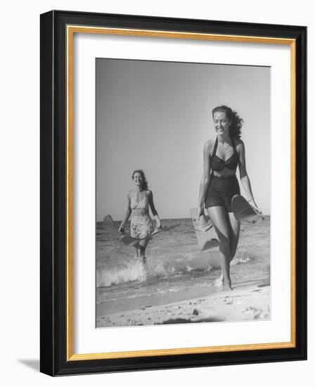 Smiling Girls Carrying Skis Out of the Water onto Beach-null-Framed Photographic Print